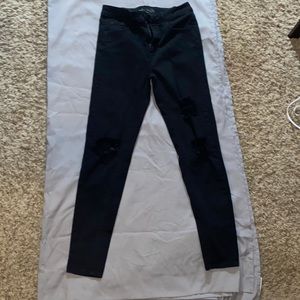 Black ripped at the knees jeans size 4 worn one time, washed once.